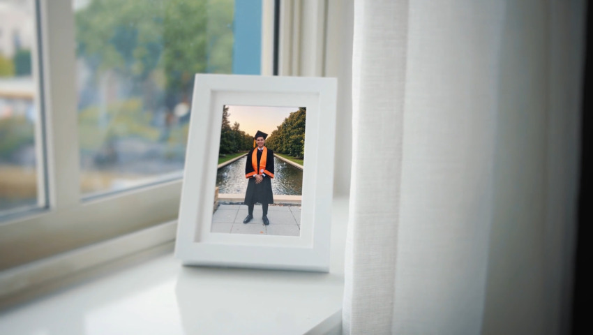 photo of man wearing graduation dress